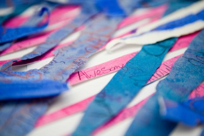 Blue and pink fabric strips with writing on