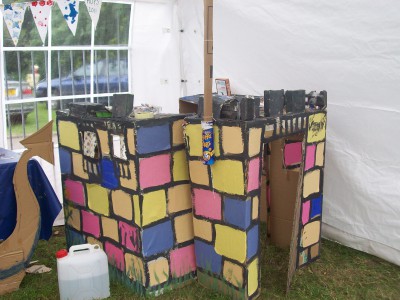 Multicoloured cardboard castle in a marquee