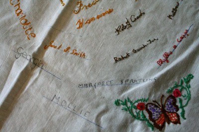 Hand-embroidered table cloth, with butterflies and peoples' names
