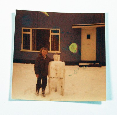 Polaroid photo of child with a snowman