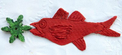 Red clay fish with green decoration