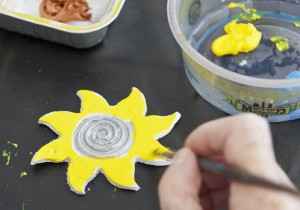 Painting a clay sun yellow