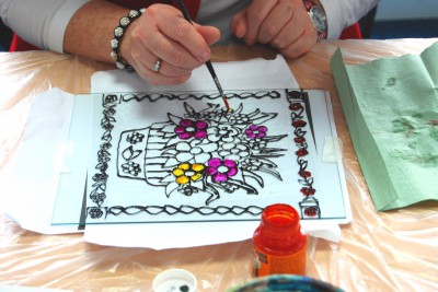 Painted purple and yellow flowers on glass